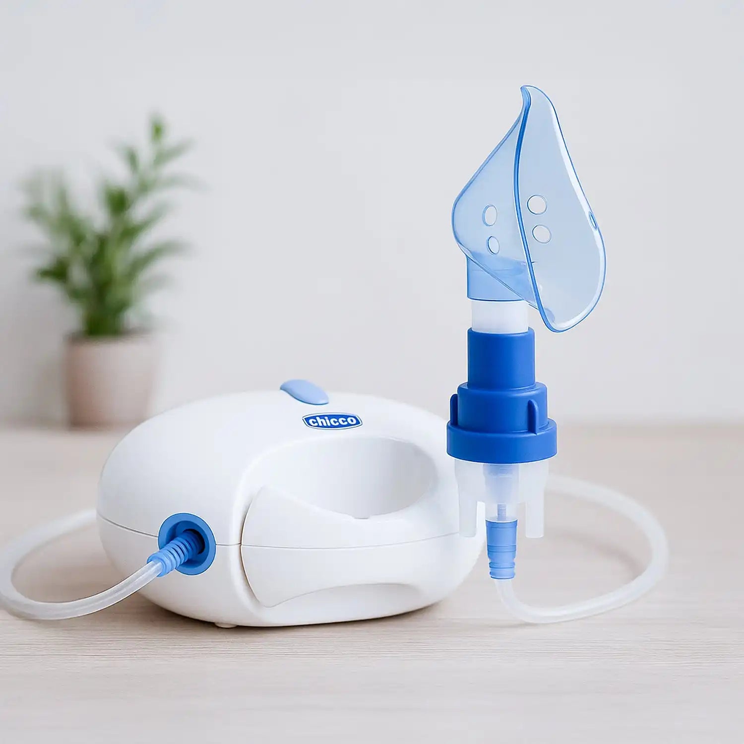 Nebulizer with blue and white design, clear mask attachment, and chicco brand.