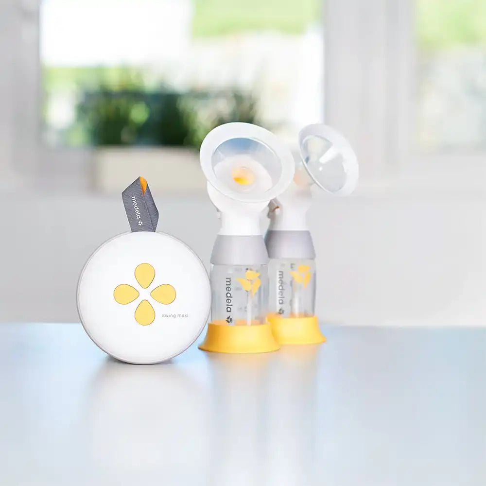 White and yellow electric double breast pump with bottles.
