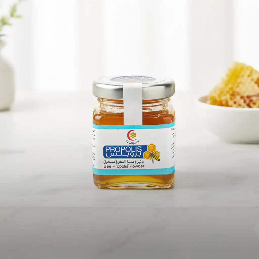 Bee propolis powder jar with blue and white label, glass container.