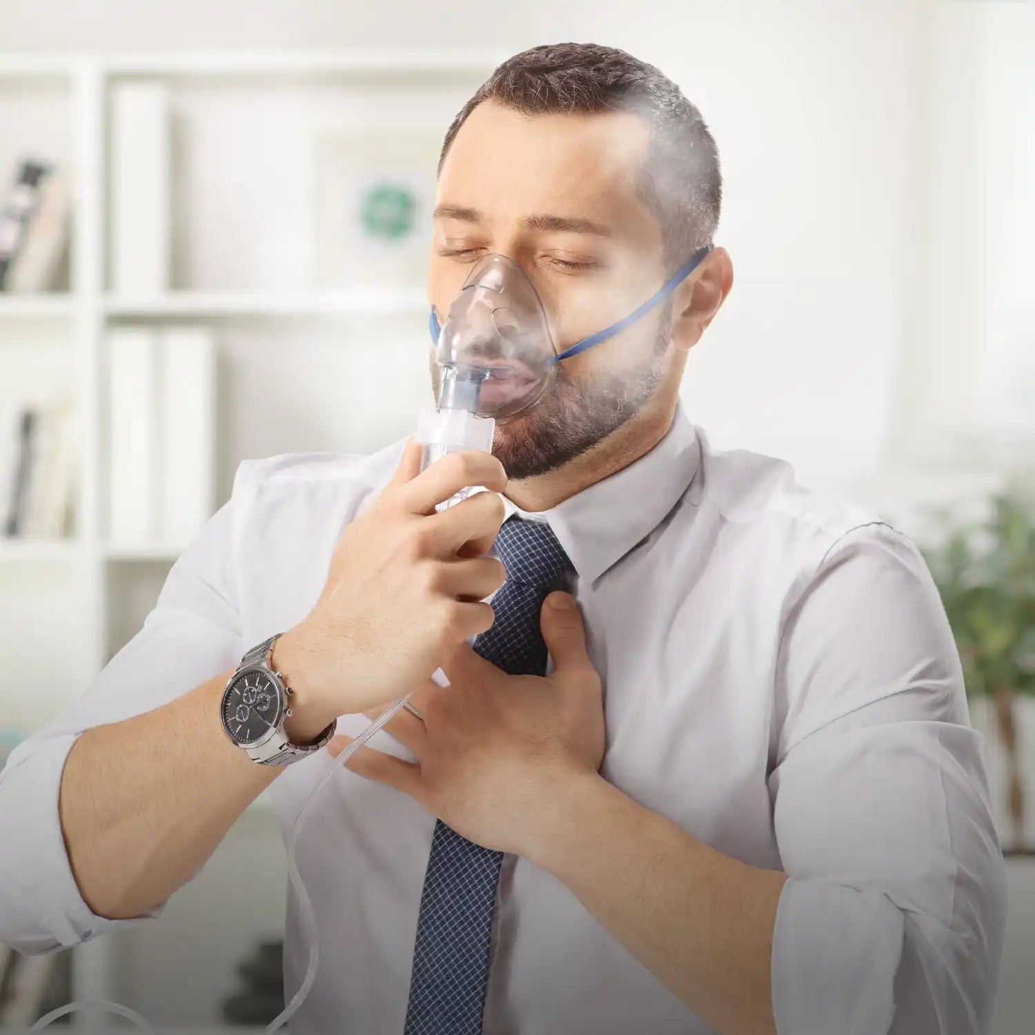 Nebulizer mask with clear plastic chamber and blue tubing.