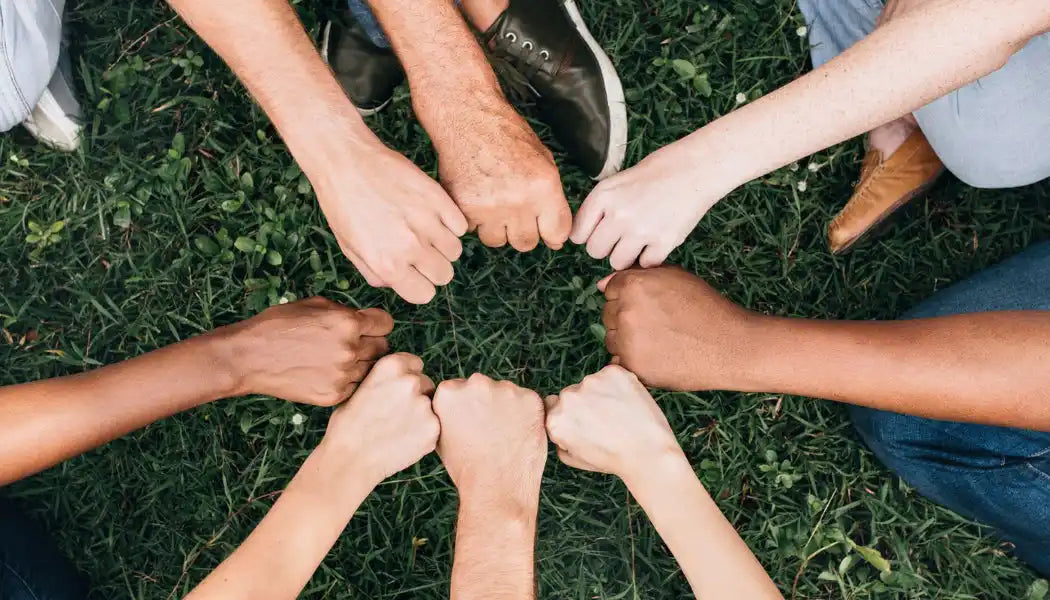 Diverse hands in a circle.