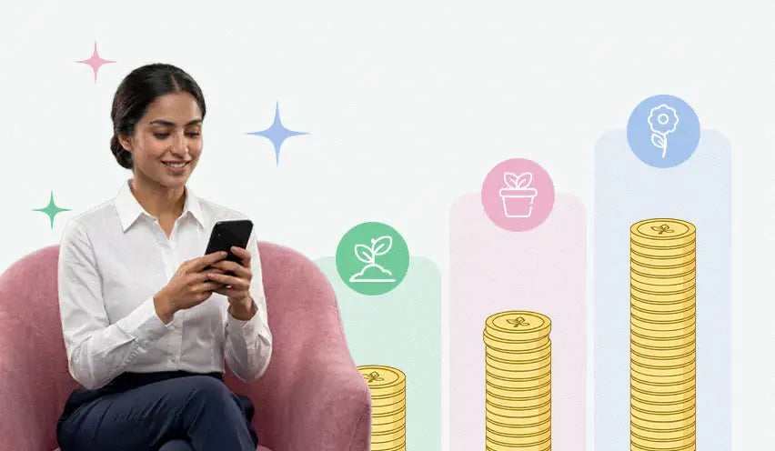 A woman in a white blouse sits comfortably on a pink armchair, holding and looking at her black smartphone.