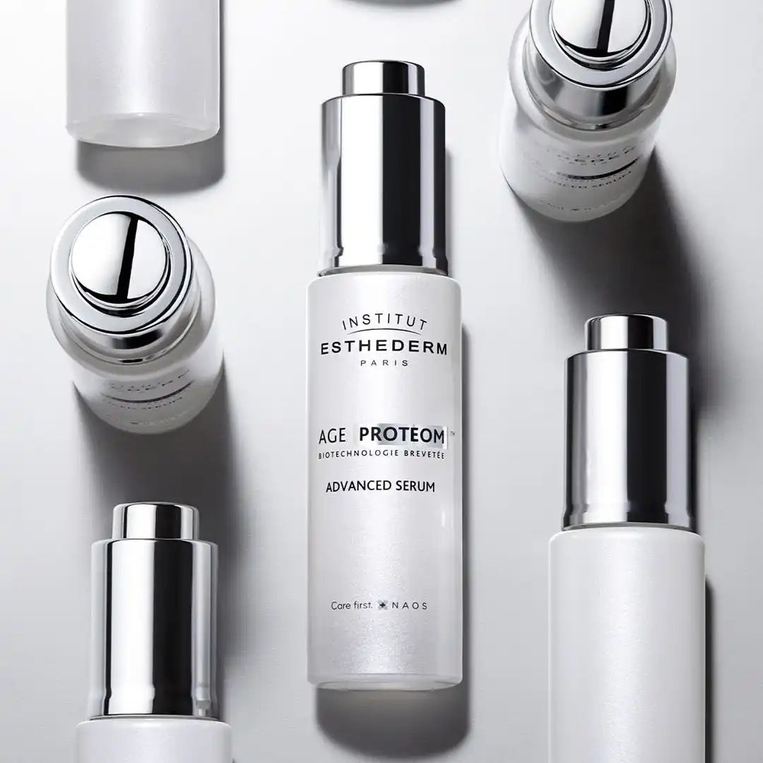 White skincare serum bottle with a silver pump dispenser.
