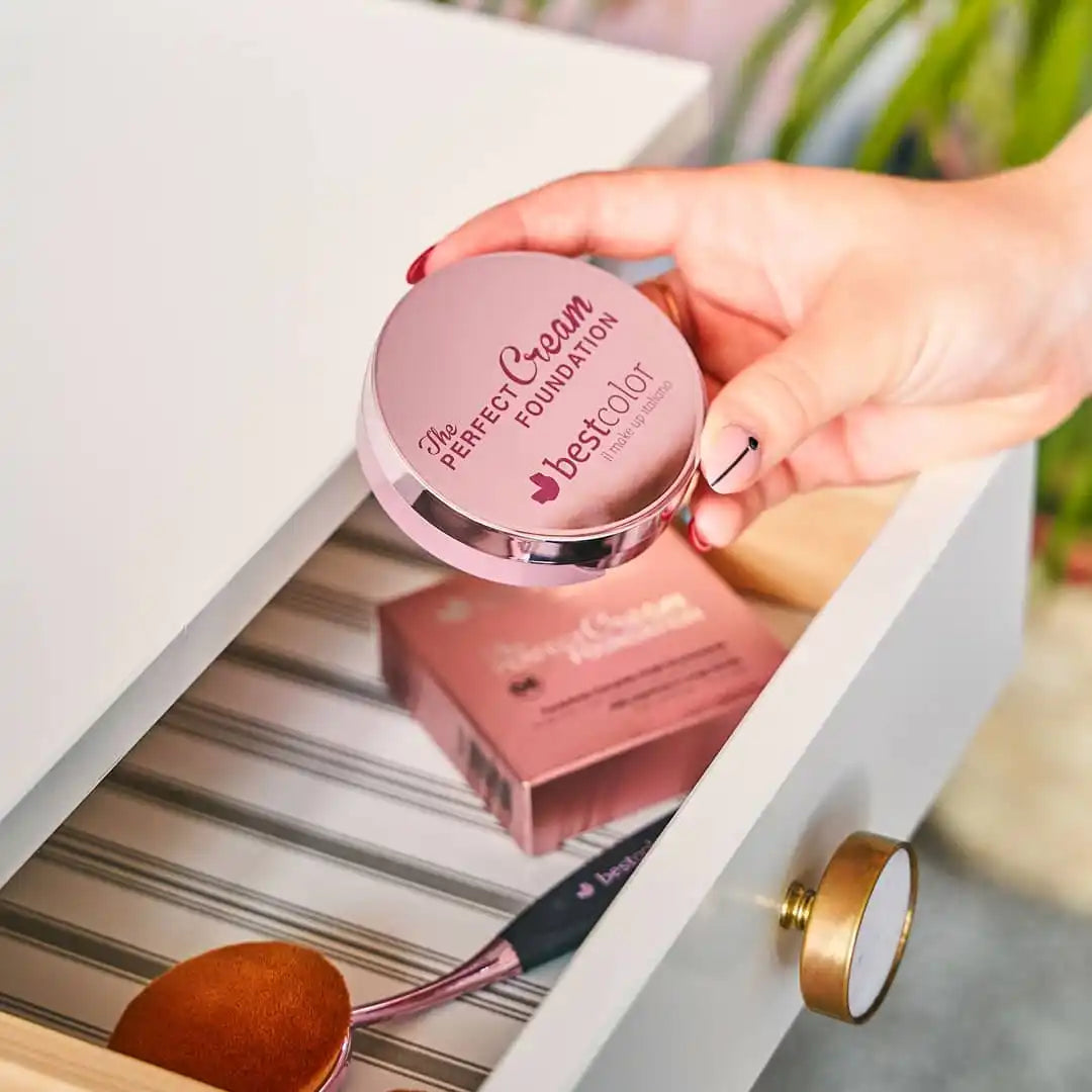 Pink compact foundation with a metallic rim.