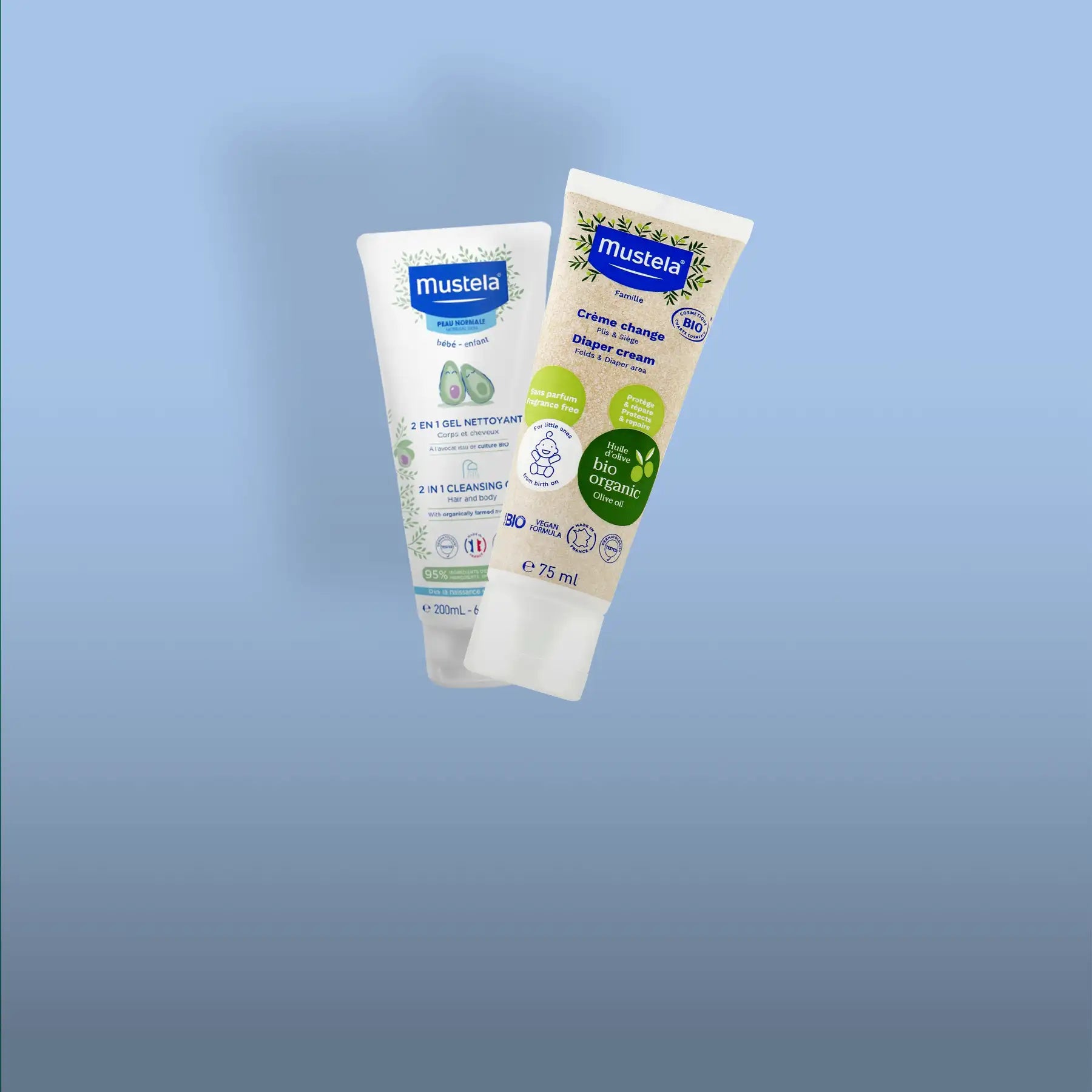 Two mustela baby care product tubes, one white with green avocado imagery labeled as a 2-in-1 cleansing gel and the other beige with leafy design for diaper cream.