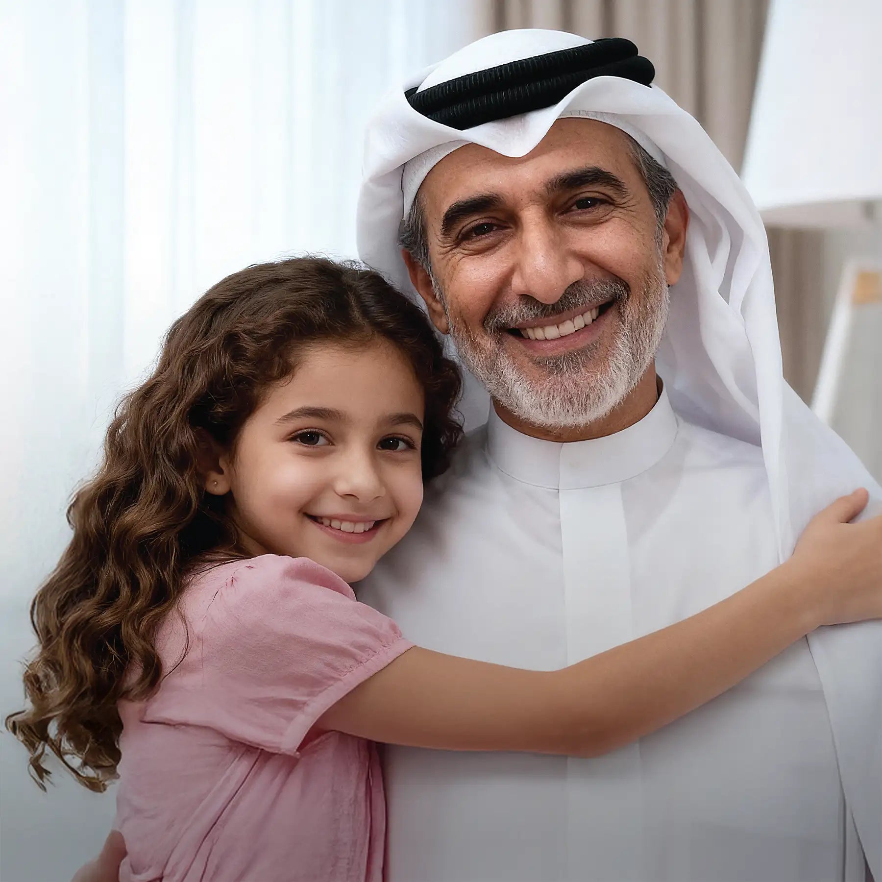 A young girl with curly brown hair wearing a soft pink short-sleeved dress.