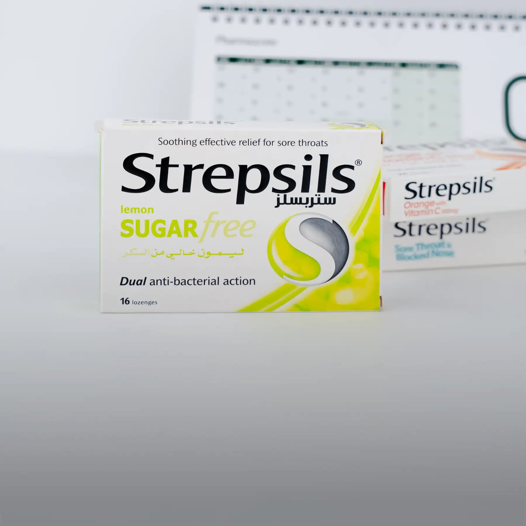 Lemon-flavored sugar-free strepsils lozenge box with a white and yellow design featuring the brand’s logo.