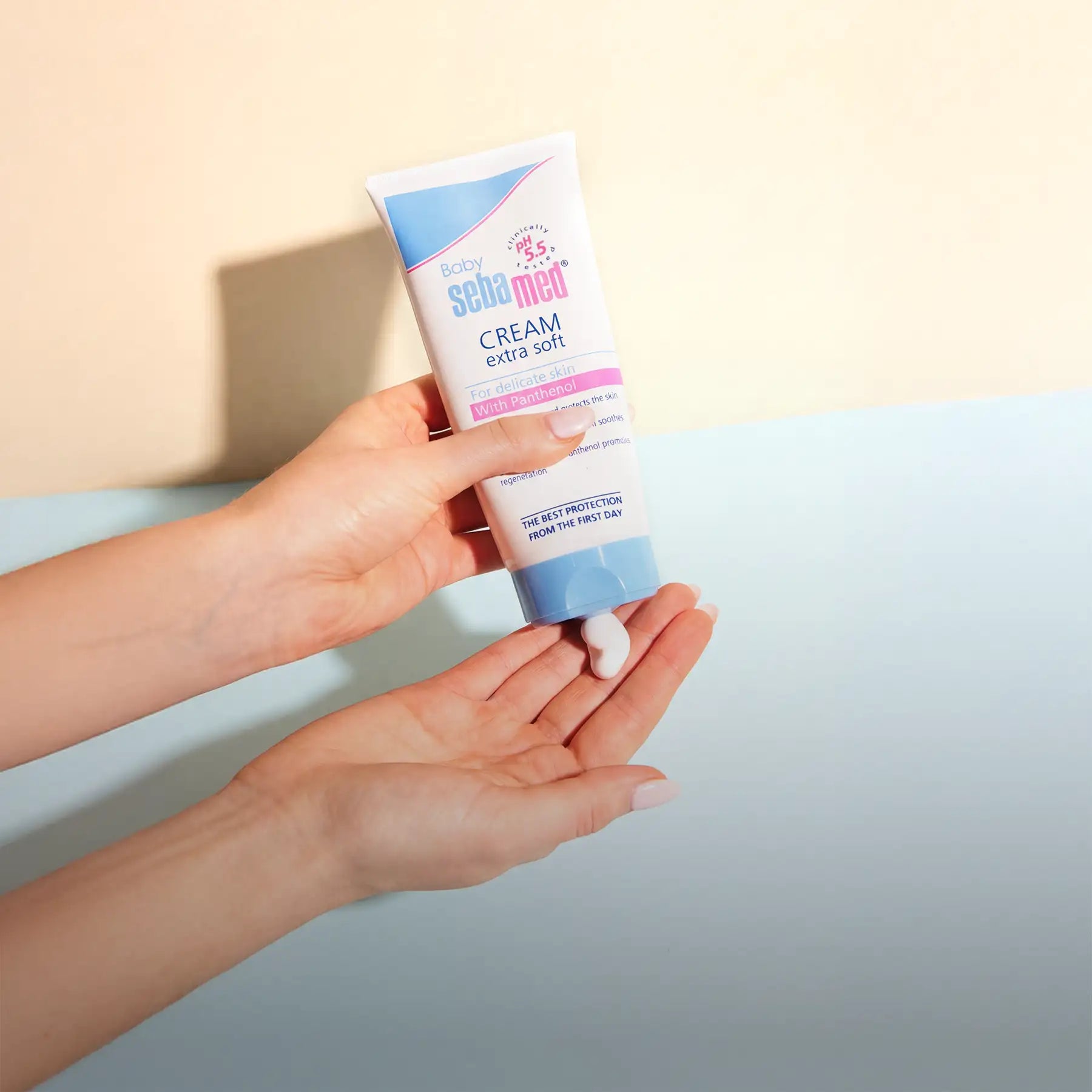 A white and blue tube of sebamed baby cream extra soft with a light pink accent, designed for delicate skin.