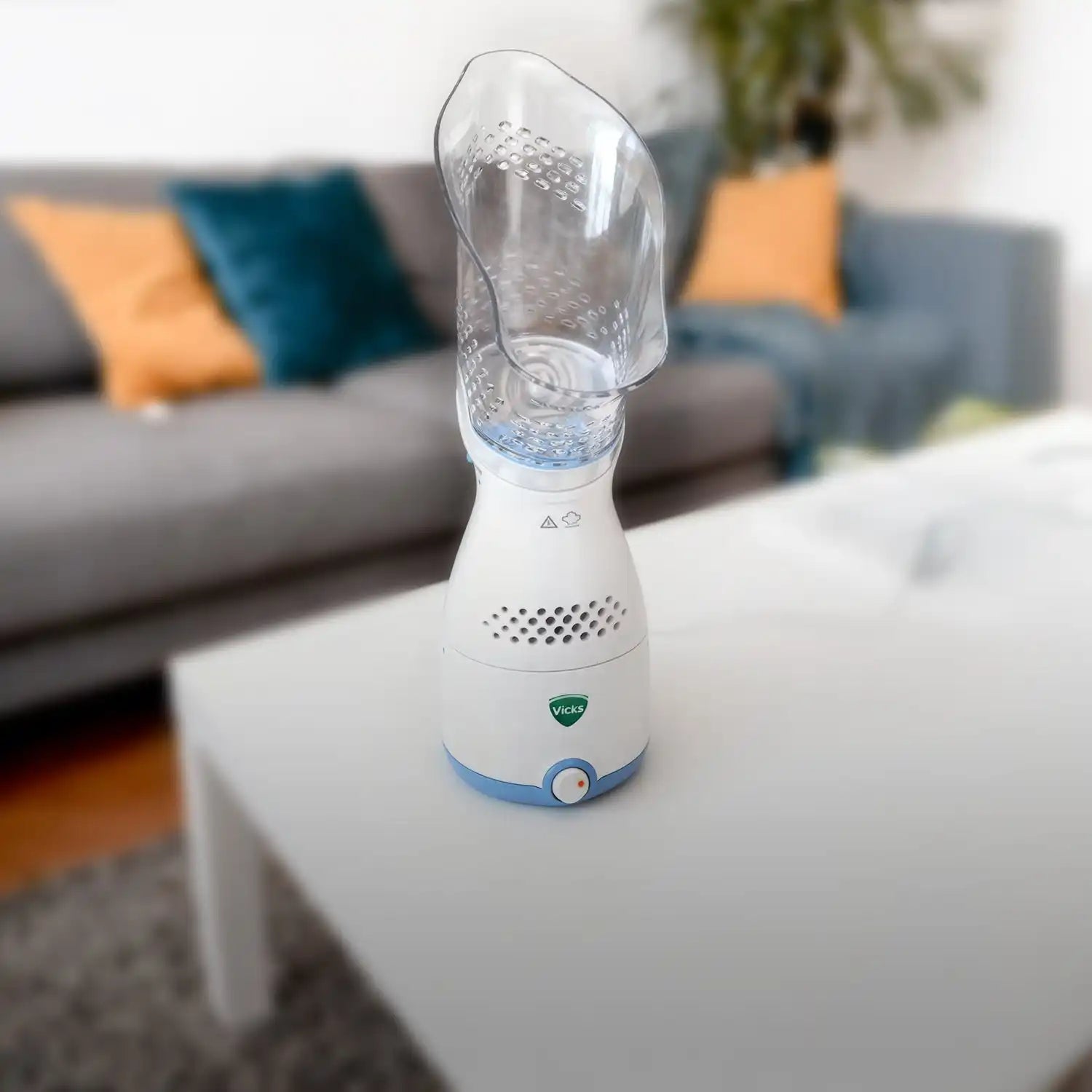 White and blue vicks humidifier with clear water tank.