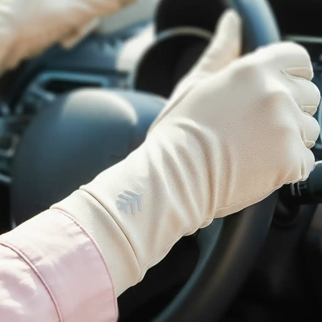 A cream-colored long driving glove with a subtle arrow pattern on the wrist.