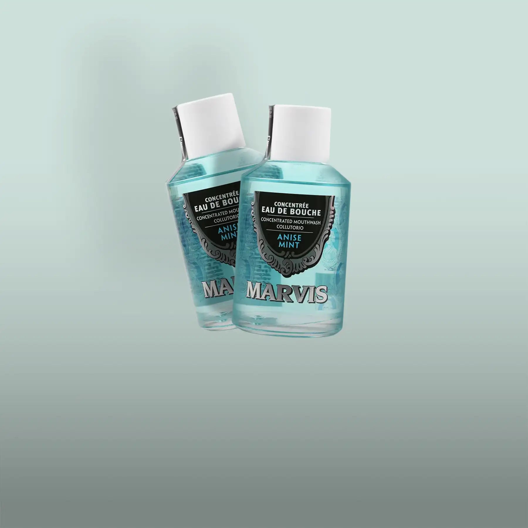 Two transparent bottles of marvis anise mint concentrated mouthwash, each with a white cap and black label featuring silver ornate detailing.