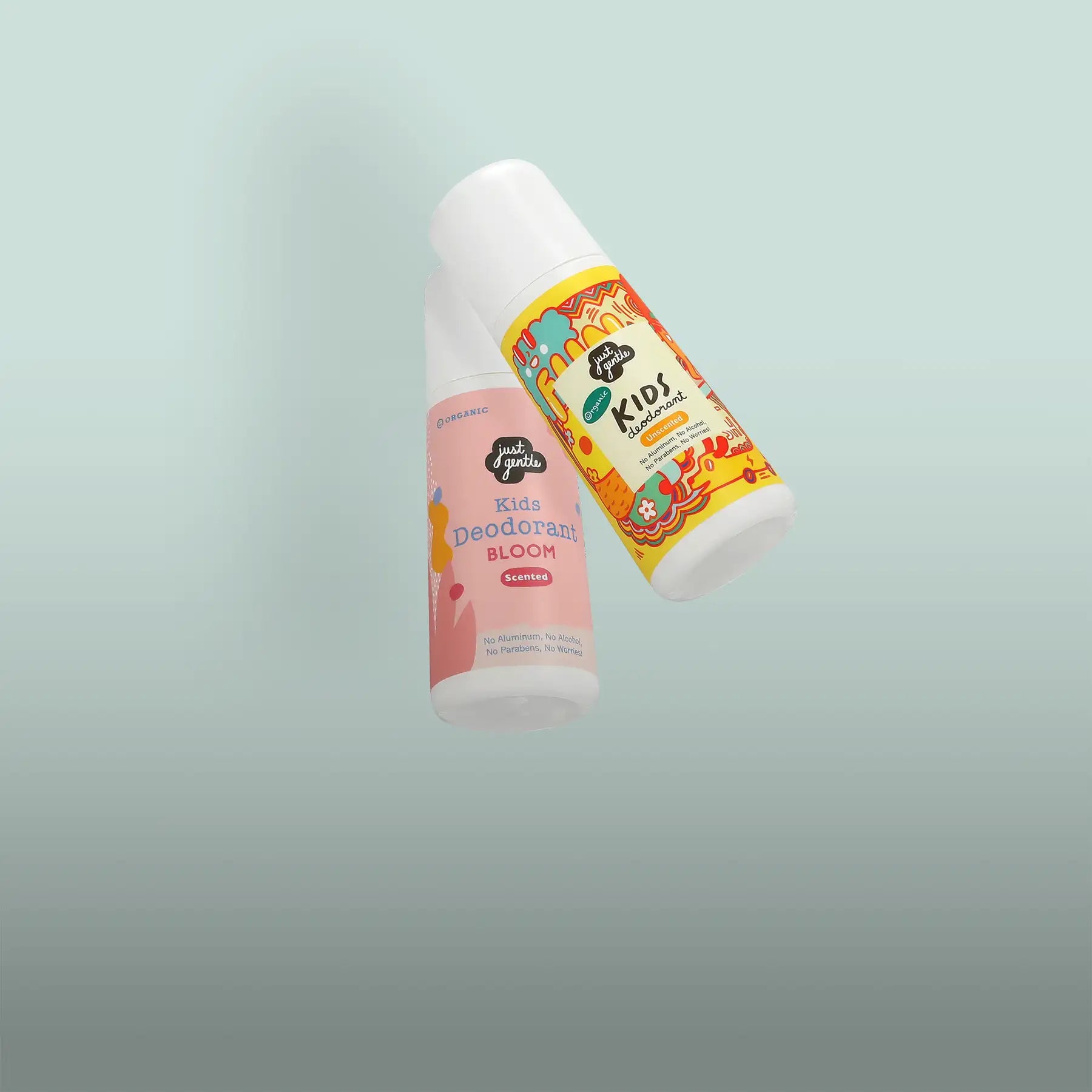 Two just grits kids deodorant roll-ons, one in pink labeled ’bloom’ and the other in yellow with a colorful floral design.