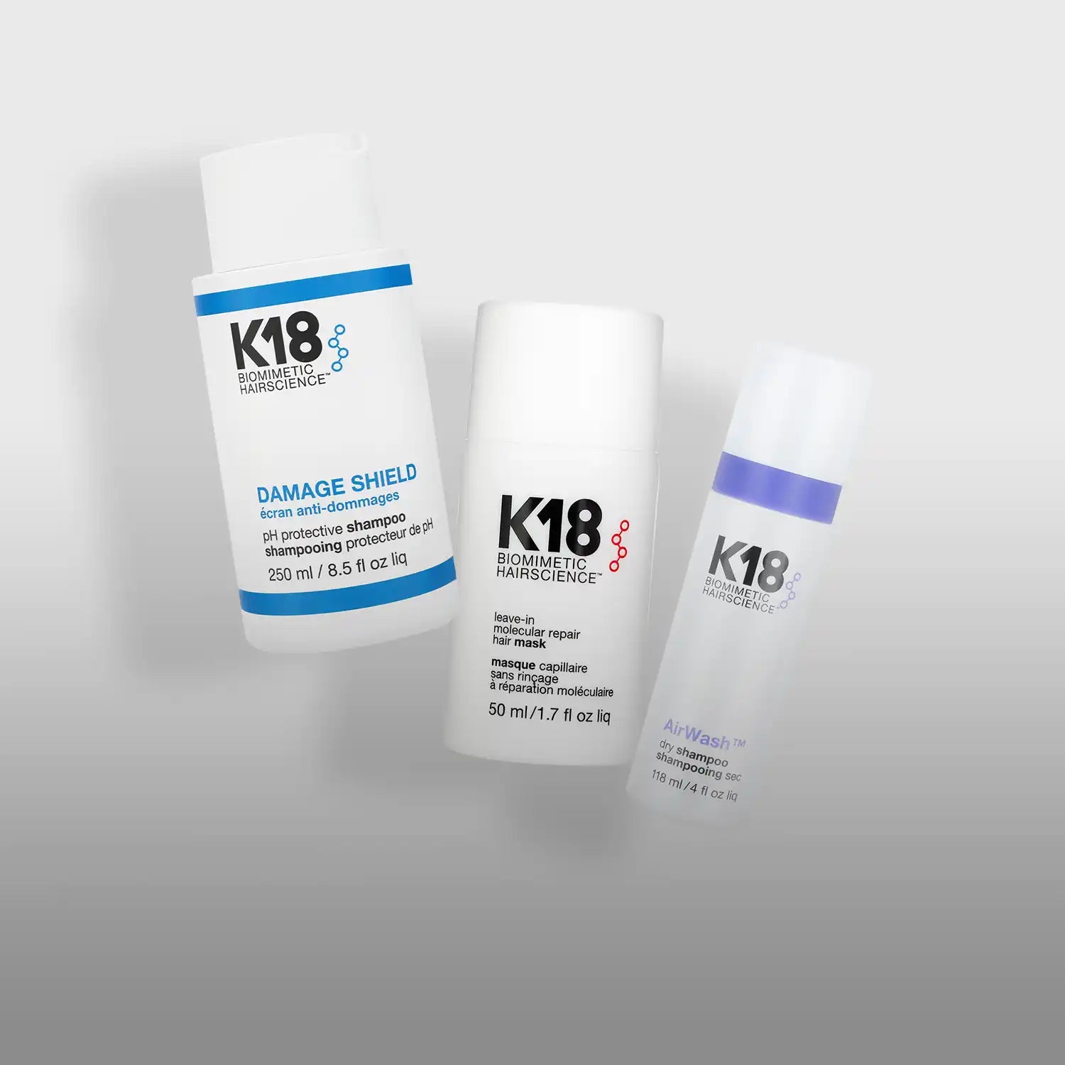 K18 damage shield bottle with white cap and blue label.