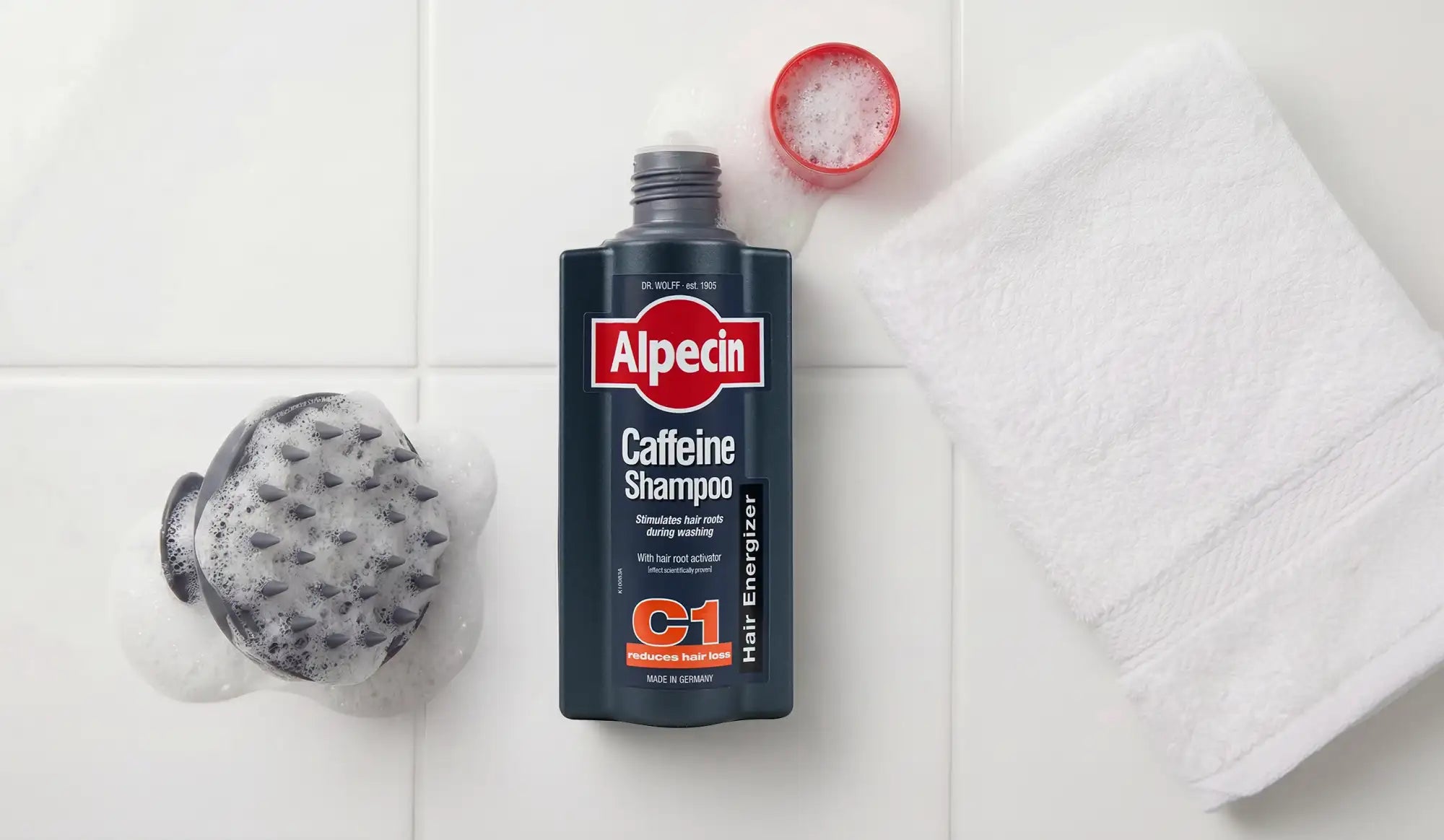 Dark blue alpecin c1 hair energizer caffeine shampoo bottle with red and white branding.