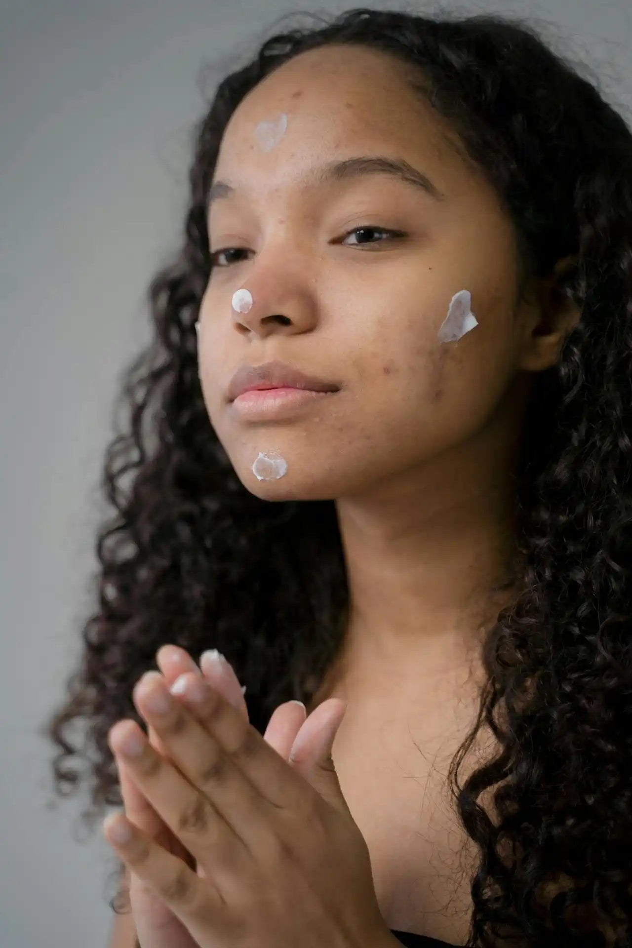 Young woman with skincare cream.