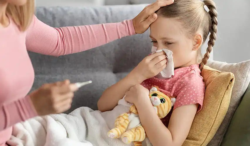 Pink polka dot dress with cat plush toy