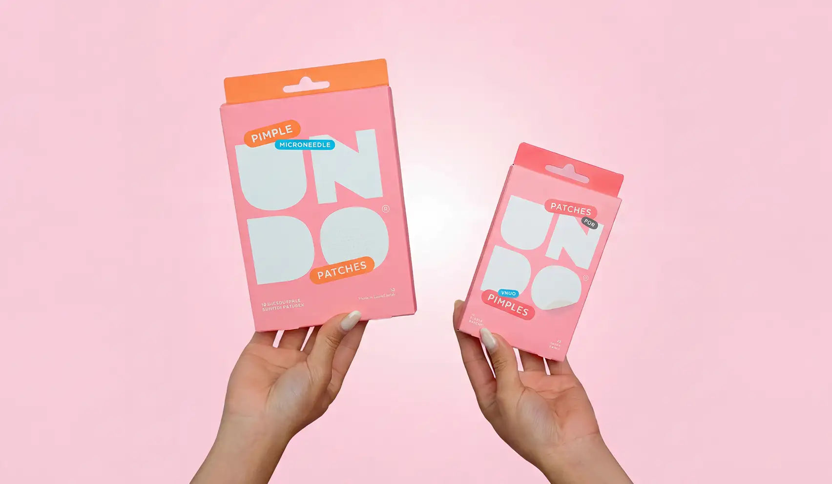 Pink rectangular packaging for pimple undo microneedle patches, featuring white and orange branding with a clear window showcasing the product inside.