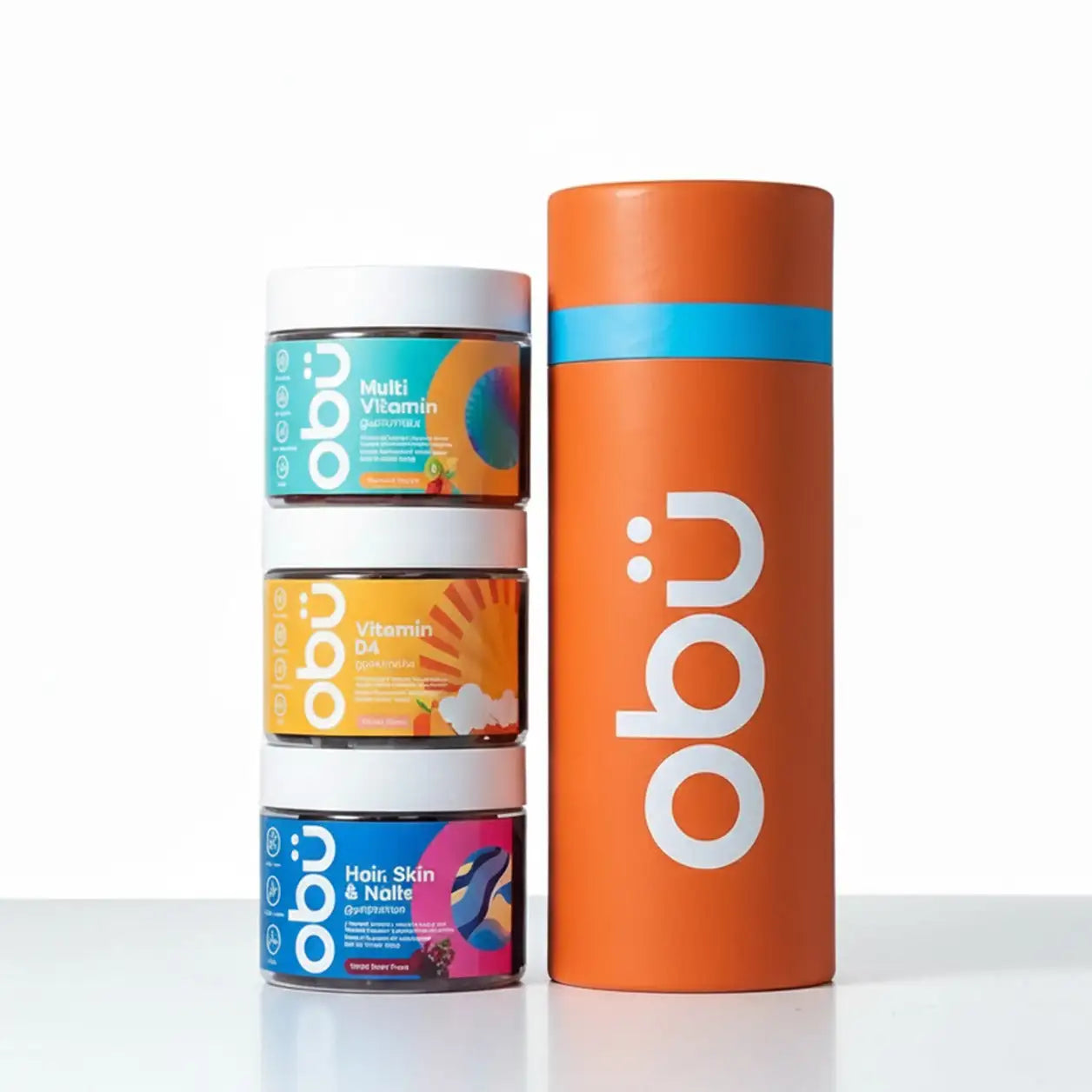 Orange cylindrical container with white ’obu’ logo and blue band, holding three stacked jars of colorful gummy vitamins.