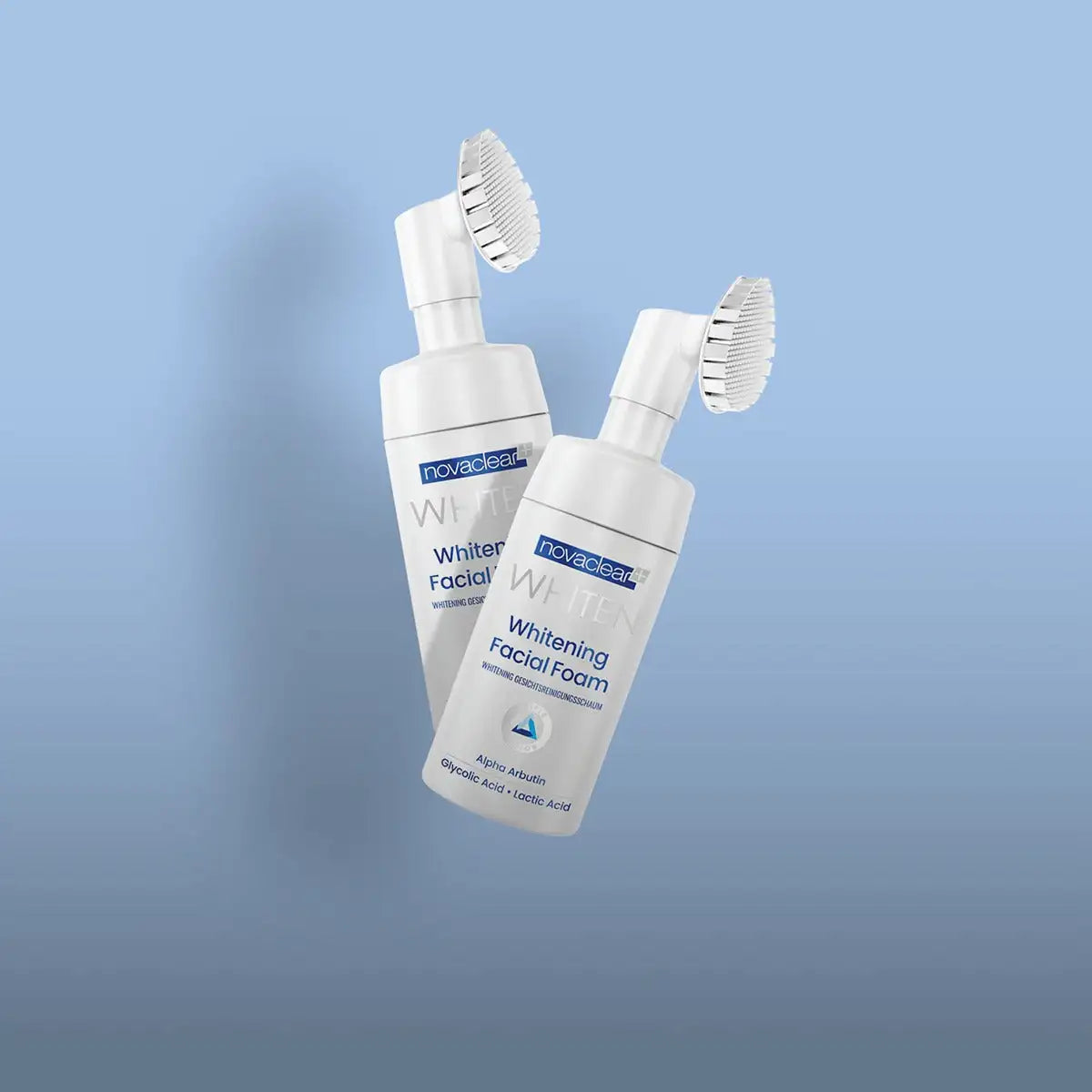 Two white novaclear whitening facial foam bottles with attached brush attachments.