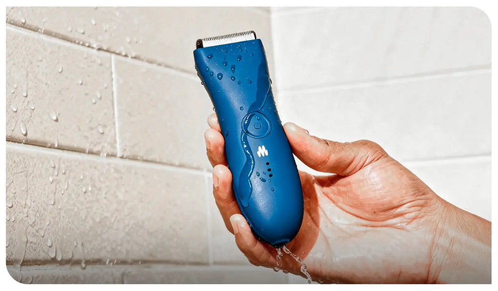 Blue waterproof electric hair trimmer with textured grip and circular power button